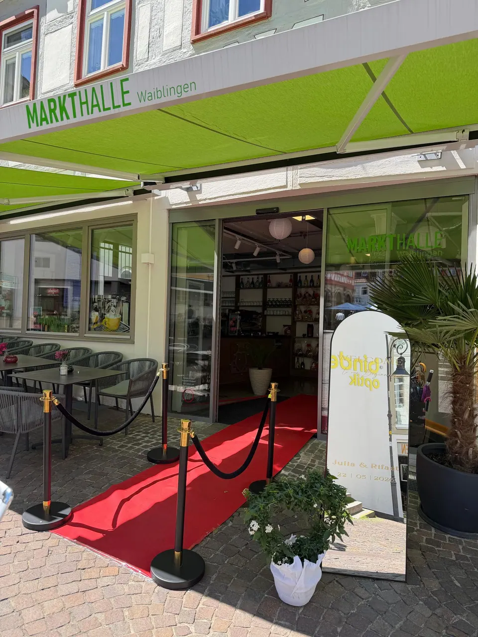 Roter Teppich mit Absperrkordeln vor dem Eingang der Markthalle