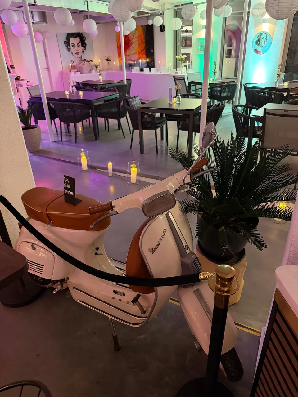 Eine Vespa als Deko in der festlich beleuchteten Markthalle